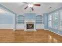 Living room featuring a cozy fireplace with built-in shelves and natural light at 6206 Carriage Gate Se Ln # 6, Mableton, GA 30126
