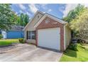 Angle view of the house exterior featuring a single car garage and manicured lawn in a residential community at 1321 Waterton Trl, Douglasville, GA 30134