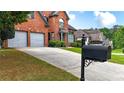 Well-maintained driveway leading to a charming brick home with a manicured front yard at 4963 Kingsbridge Ct, Powder Springs, GA 30127