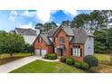 Beautiful brick two-story home with mature trees and a well-maintained lawn at 4963 Kingsbridge Ct, Powder Springs, GA 30127