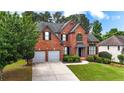 Traditional brick home with a manicured lawn and lush landscaping in a desirable neighborhood at 4963 Kingsbridge Ct, Powder Springs, GA 30127