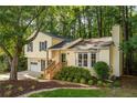 Two-story home boasts a lush lawn and mature trees providing shade and privacy at 5999 Brookside Se Ln, Mableton, GA 30126