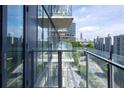Condo balcony overlooking the city with glass railings and outdoor seating at 788 W Marietta Nw St # 311, Atlanta, GA 30318