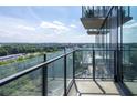 Condo balcony featuring glass railings with a view of the surrounding trees at 788 W Marietta Nw St # 311, Atlanta, GA 30318