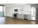 Modern kitchen featuring stainless steel appliances, white cabinets, and hardwood floors at 788 W Marietta Nw St # 311, Atlanta, GA 30318