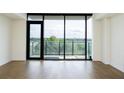 Bright living room with hardwood floors and a large window overlooking the trees at 788 W Marietta Nw St # 311, Atlanta, GA 30318