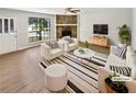 Bright living room boasts a stone fireplace, neutral paint, and modern furniture for a cozy, stylish space at 2492 Wild Rose Cir, Lawrenceville, GA 30044