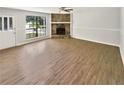 Spacious living room features wood-look floors, stone fireplace, neutral paint, and a large window at 2492 Wild Rose Cir, Lawrenceville, GA 30044