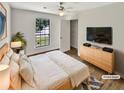 Inviting bedroom with a light wood bed frame, dresser, large window, and closet for ample storage at 2492 Wild Rose Cir, Lawrenceville, GA 30044