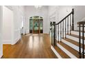 Spacious foyer with hardwood floors, staircase, and elegant chandelier at 10635 N Edgewater, Johns Creek, GA 30097