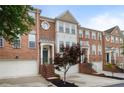 Attractive brick townhouse with a two-car garage and landscaped front with mature tree at 4855 Payson Se Ter # 3, Atlanta, GA 30339