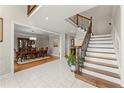 Spacious foyer with a staircase and iron spindles, adjacent to the dining room, offering an open layout at 789 Rutland Ct, Lithonia, GA 30058
