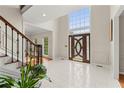 Grand two-story foyer with tile floors, a decorative front door, and a large window allowing natural light at 789 Rutland Ct, Lithonia, GA 30058