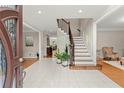 Bright foyer featuring tile flooring, a staircase with iron spindles, and views into adjacent rooms at 789 Rutland Ct, Lithonia, GA 30058