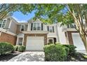 Charming home featuring stone accents, a two-car garage, and well-maintained landscaping at 129 Finsbury Ln, Woodstock, GA 30188
