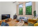 Cozy living room with hardwood floors, comfortable seating, and large windows with views of surrounding greenery at 19 Hilliard Se St # 13, Atlanta, GA 30312