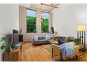 Relaxing living room with hardwood floors, comfortable seating, and views of lush greenery through expansive windows at 19 Hilliard Se St # 13, Atlanta, GA 30312