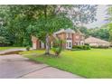 Beautiful two-story brick home with well-maintained lawn and driveway at 214 Jamestown Ave, Jonesboro, GA 30236