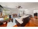 Spacious living room with hardwood floors, a cozy fireplace, and lots of natural light, creating a warm atmosphere at 1364 Keys Crossing Ne Dr, Atlanta, GA 30319