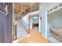 Grand foyer with staircase featuring wood and iron banisters and hardwood floors at 1850 Noblin Ridge Way, Duluth, GA 30097