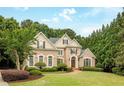 Charming brick home with well-kept lawn, manicured bushes, and a symmetrical design, perfect for families at 314 Caruso Ct, Sandy Springs, GA 30350