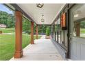 Inviting covered porch with stylish columns and a charming entryway with ample natural light at 347 Chip Rd, Stone Mountain, GA 30087