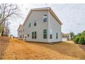 Back exterior of home with neutral siding and large windows providing ample natural light at 4700 Blake Loop, Atlanta, GA 30349