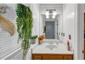Cozy half bath with window, marble countertop, vessel sink, and decorative accents at 4817 Overland Dr, Powder Springs, GA 30127