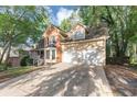 A two-story brick and siding home with a front porch and two car garage and long driveway at 4817 Overland Dr, Powder Springs, GA 30127