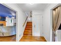 Bright foyer with hardwood floors, staircase, and doorway to living room with blue ceiling at 4817 Overland Dr, Powder Springs, GA 30127