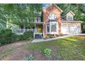 Charming two-story home boasting a brick facade, covered porch, and a two-car garage at 4817 Overland Dr, Powder Springs, GA 30127