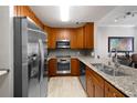 Kitchen with stainless steel appliances, granite countertops, and wood cabinets at 1101 Juniper Ne St # 1216, Atlanta, GA 30309