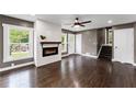 Spacious living room with fireplace, hardwood floors, and staircase access to upper level of the home at 3034 Barksdale Cir, Atlanta, GA 30344