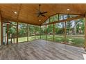 Inviting sunroom featuring a wood-paneled ceiling, tiled floor, and large screened windows offering backyard views at 3034 Barksdale Cir, Atlanta, GA 30344