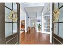 Bright foyer showcasing hardwood floors and light blue walls, leading into a spacious home at 4218 Sandy Branch Dr, Buford, GA 30519