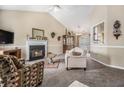 Inviting living room with a cozy fireplace, plush carpeting, and comfortable seating at 7008 Glen Valley Way, Fairburn, GA 30213