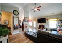 Open-concept living room with vaulted ceilings, fireplace, and modern furnishings at 504 Cole Creek Dr, Dallas, GA 30157