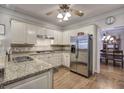 Well-equipped kitchen features granite counters, stainless appliances, and hardwood floors at 5327 Saville Nw Dr, Acworth, GA 30101