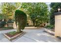 Landscaped entrance sign to Colony Park Condominiums, featuring mature shade trees and manicured landscaping at 209 14Th Ne St # 109, Atlanta, GA 30309