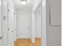 Bright hallway with neutral paint, white trim and doors, and attractive wood flooring at 209 14Th Ne St # 109, Atlanta, GA 30309