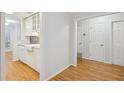 Compact kitchen area with white cabinets, stone backsplash and stainless dishwasher at 209 14Th Ne St # 109, Atlanta, GA 30309