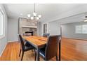 Cozy dining room featuring a fireplace, modern chandelier, and hardwood floors at 23 Hunting Creek Dr, Marietta, GA 30068