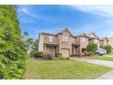 Brick townhome with an attached one-car garage and manicured lawn at 2500 Morgan Chase Dr, Buford, GA 30519
