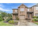 Inviting brick townhome with a one-car garage and meticulously landscaped front yard at 2500 Morgan Chase Dr, Buford, GA 30519
