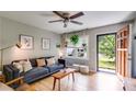 Bright living room featuring hardwood floors, a ceiling fan, and stylish furniture at 2575 Dobbs Nw Dr, Kennesaw, GA 30152