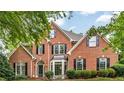 Charming brick home with lush green lawn and manicured shrubs in desirable neighborhood at 4020 Devereux Chase, Roswell, GA 30075