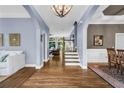 Elegant foyer with hardwood floors, arched doorways and soft blue walls at 4020 Devereux Chase, Roswell, GA 30075
