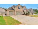 Beautiful brick home with a three-car garage and well-manicured lawn and front yard at 4708 Tiger Blvd, Duluth, GA 30096