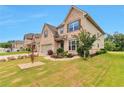 Lovely home with three-car garage and an inviting front yard with manicured landscaping at 4708 Tiger Blvd, Duluth, GA 30096