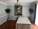 Formal dining room featuring hardwood floors, elegant chandelier, and large decorative artwork at 1159 Aurora Ct, Atlanta, GA 30338